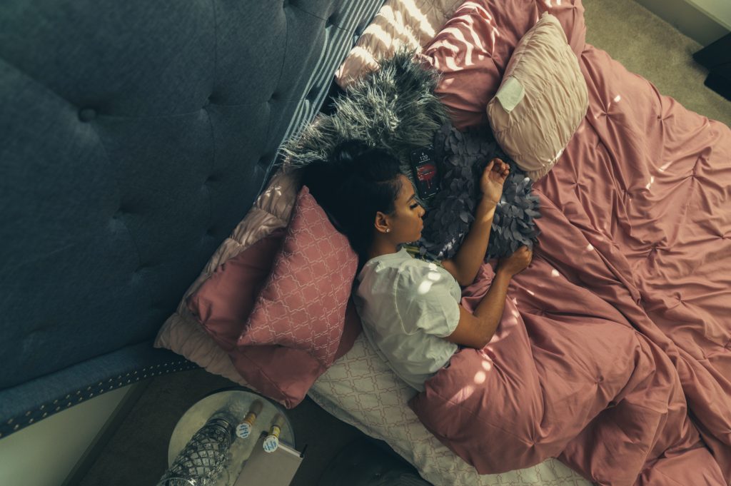 a girl sleeping in a heavy blanket