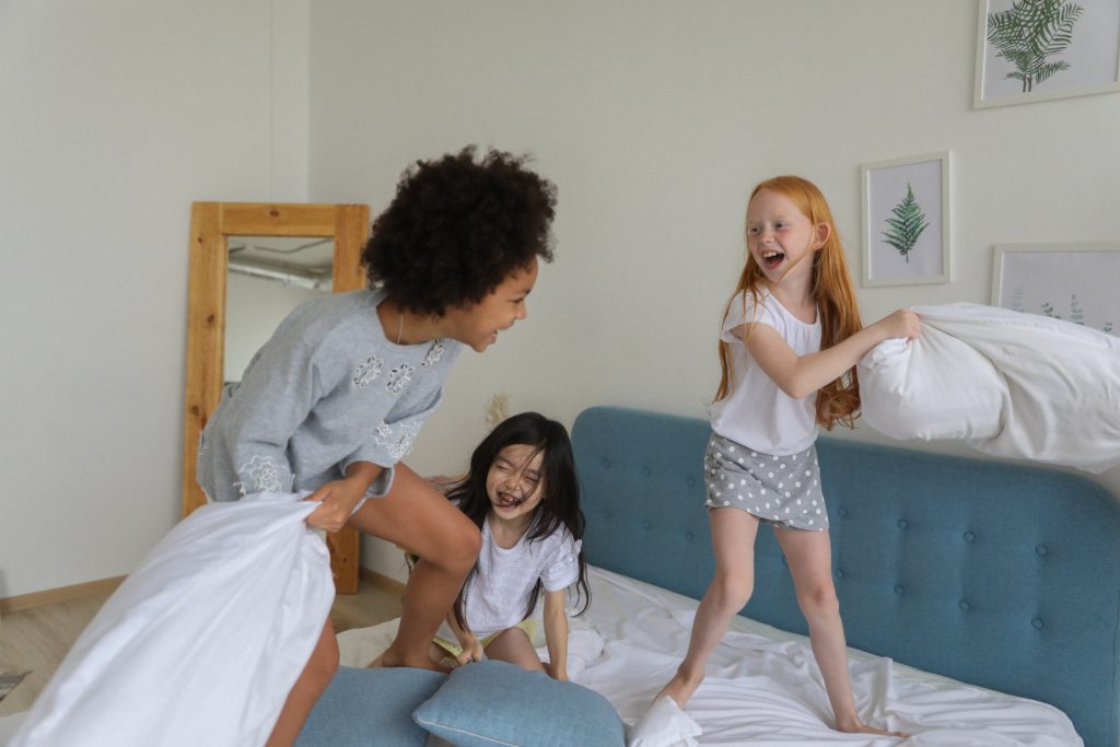 kids pillow fight in indoor camping